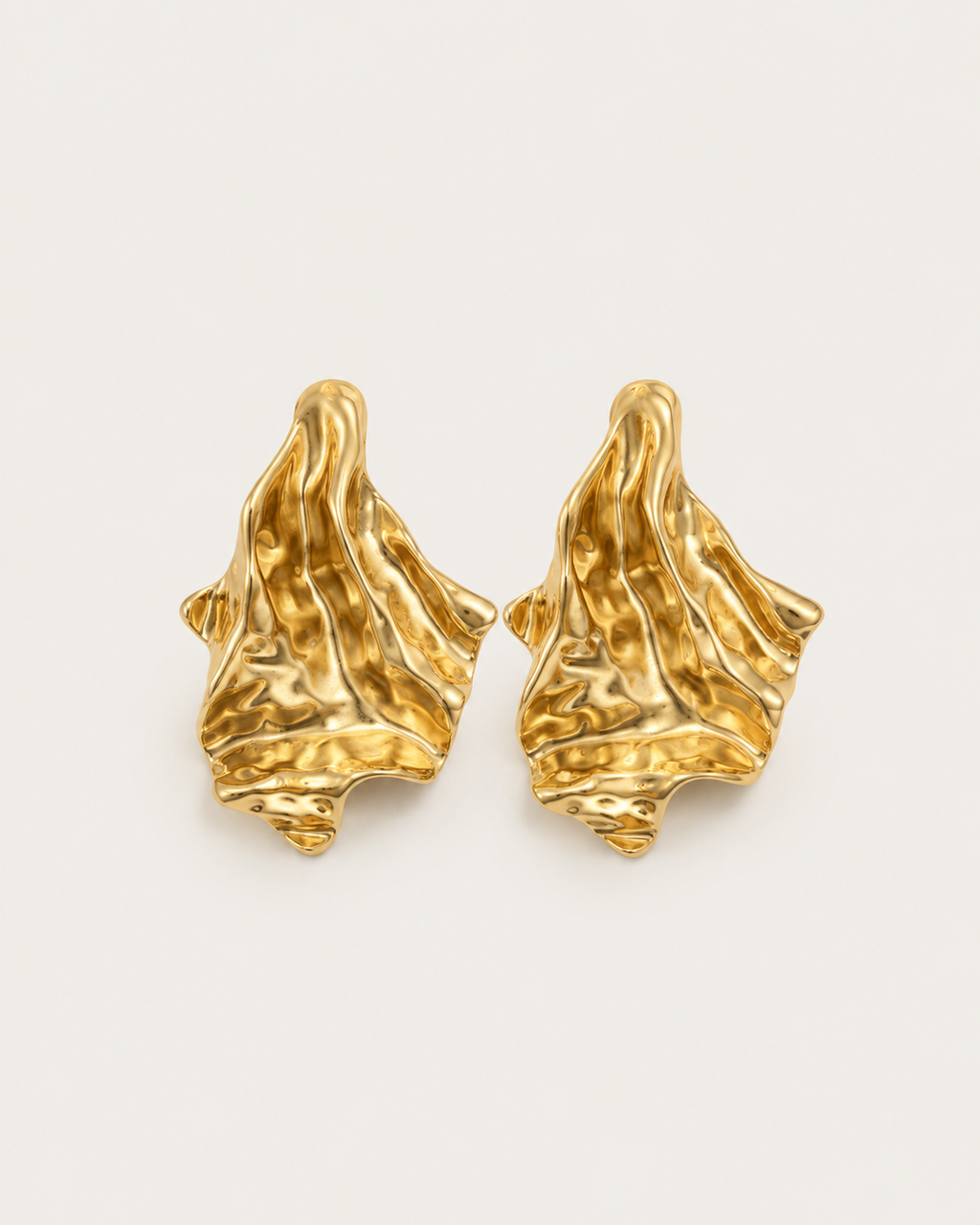 Pair of gold-tone flared earrings with folded surfaces, shown together.