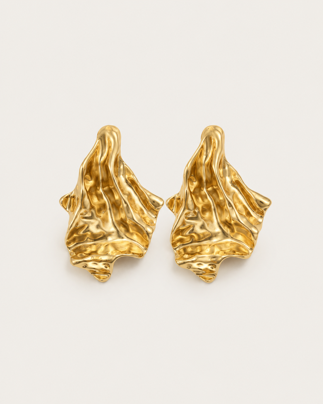 Pair of gold-tone flared earrings with folded surfaces, shown together.