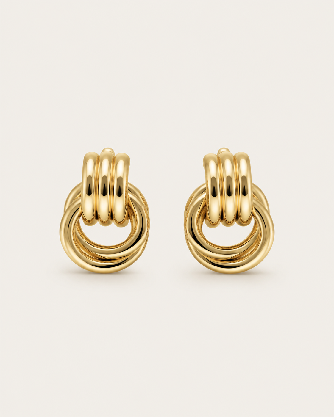 Pair of gold-tone circle drop earrings with small linked upper sections, shown together.