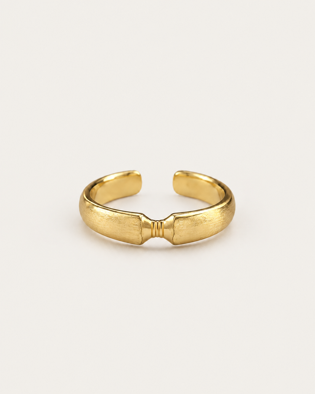 Gold-tone open ribbon-knot ring with a narrow ridged centre.