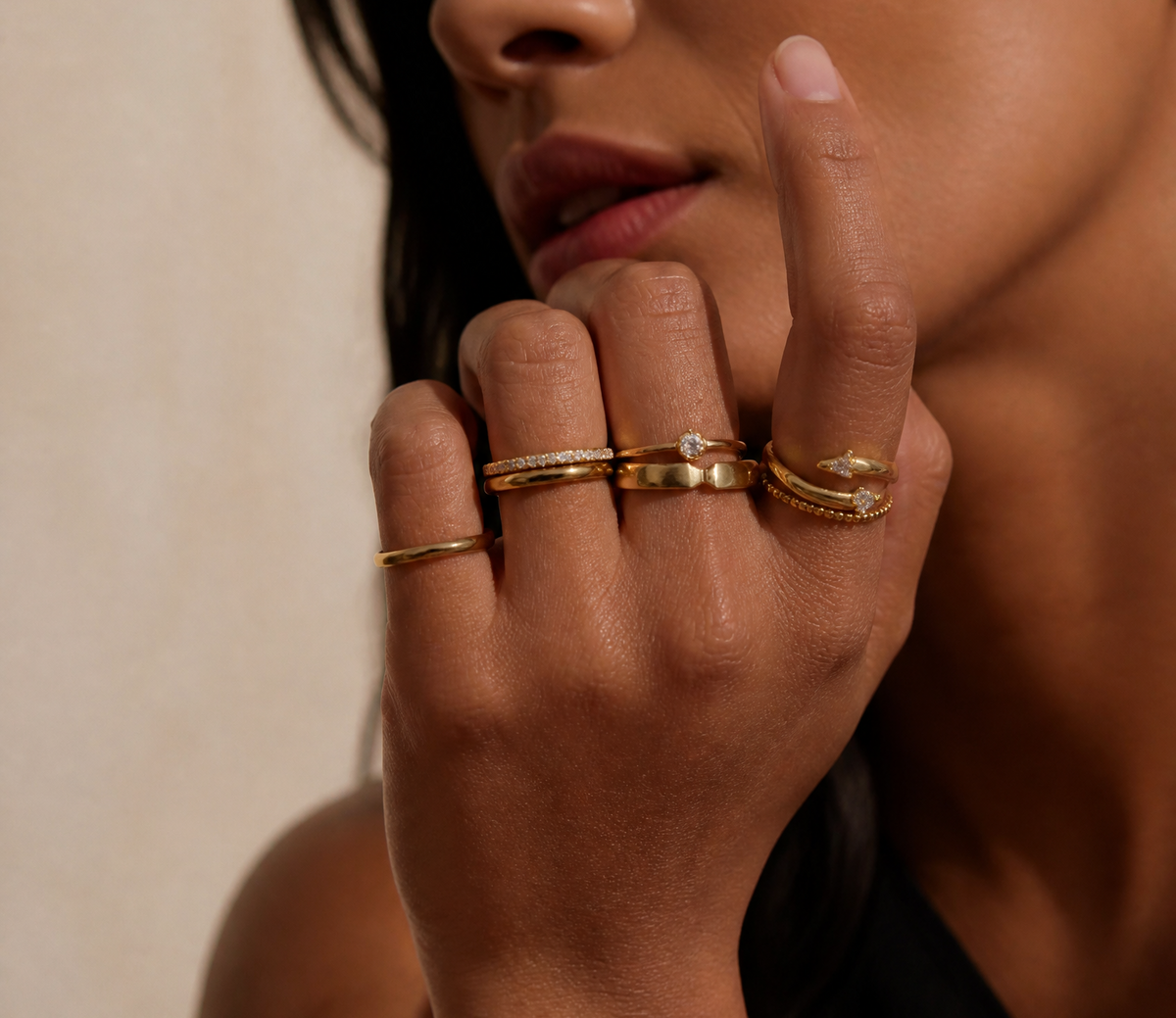 Close-up of a hand wearing stacked rings.